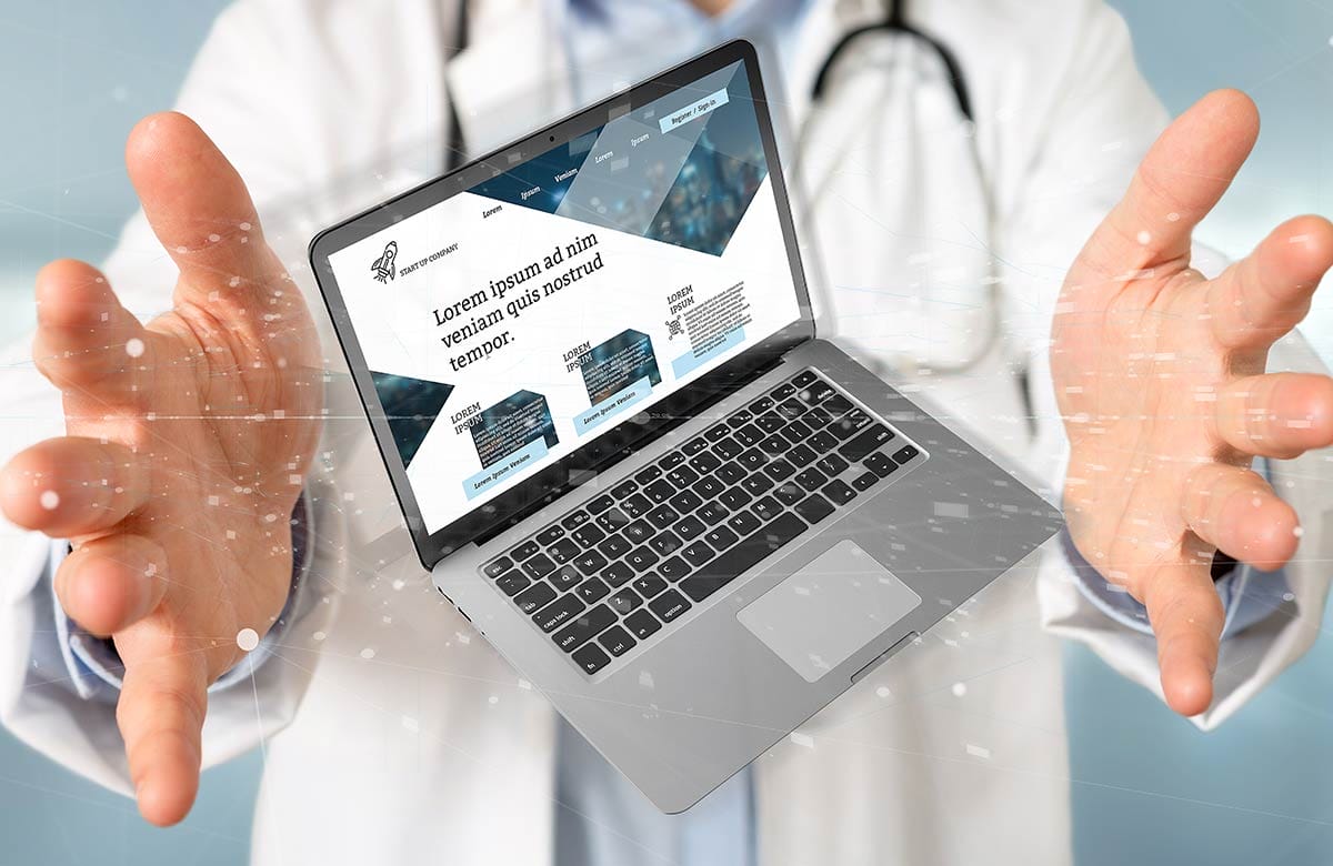 Doctor Holding Laptop With Healthcare Website Showing