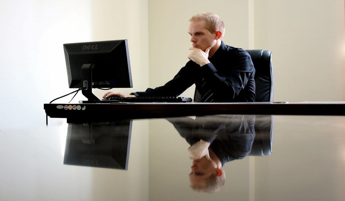 Person In Black Clothes Checking Computer